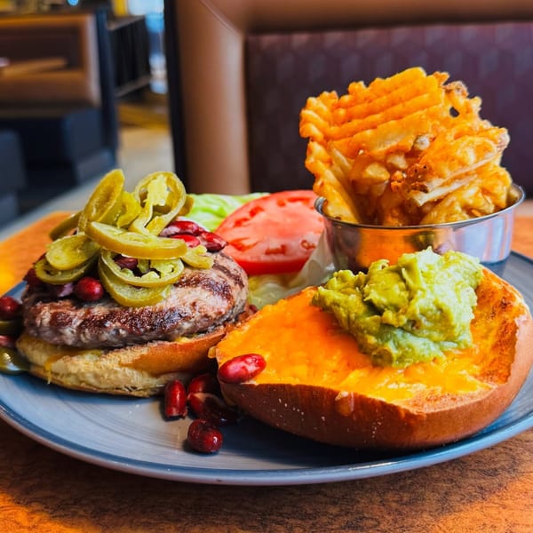 A Georgia Diner burger with jalapeños, waffle fries, and a loaded baked potato.